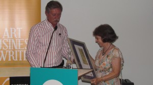 Sandy receiving her award from the chair of the QWC,